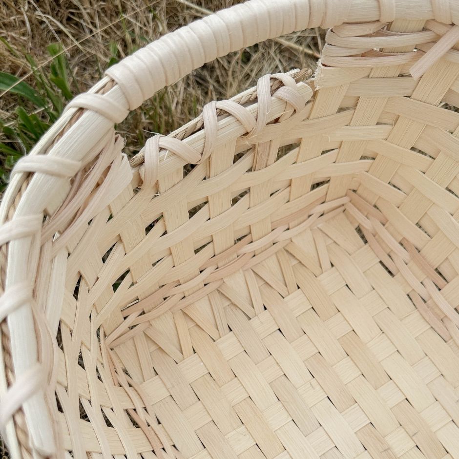 Detail image of the inside of the handled storage basket. 