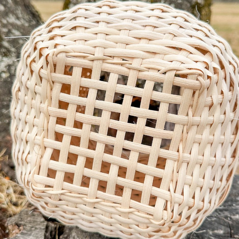 Bottom view detail of an open weave on a stair step weave basket. 