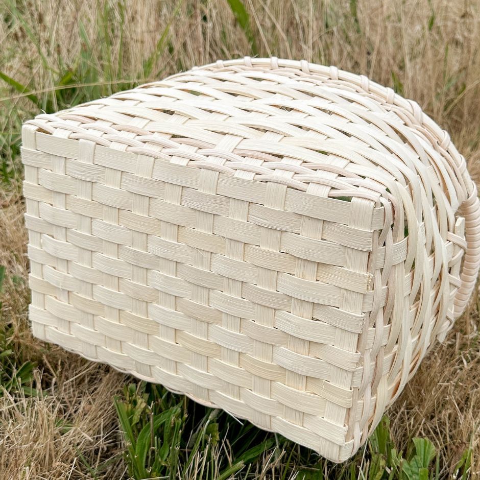 Bottom of the handled storage basket showing the closed weave base.