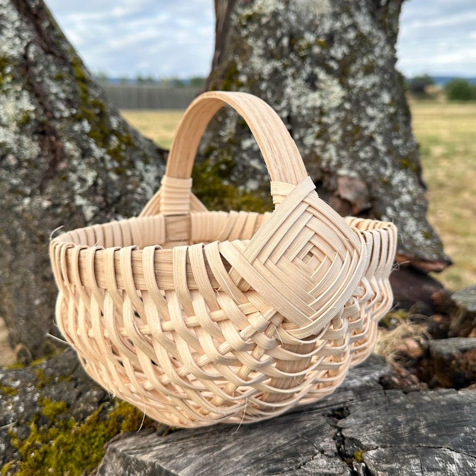 A melon basket sits on a tree stump. 