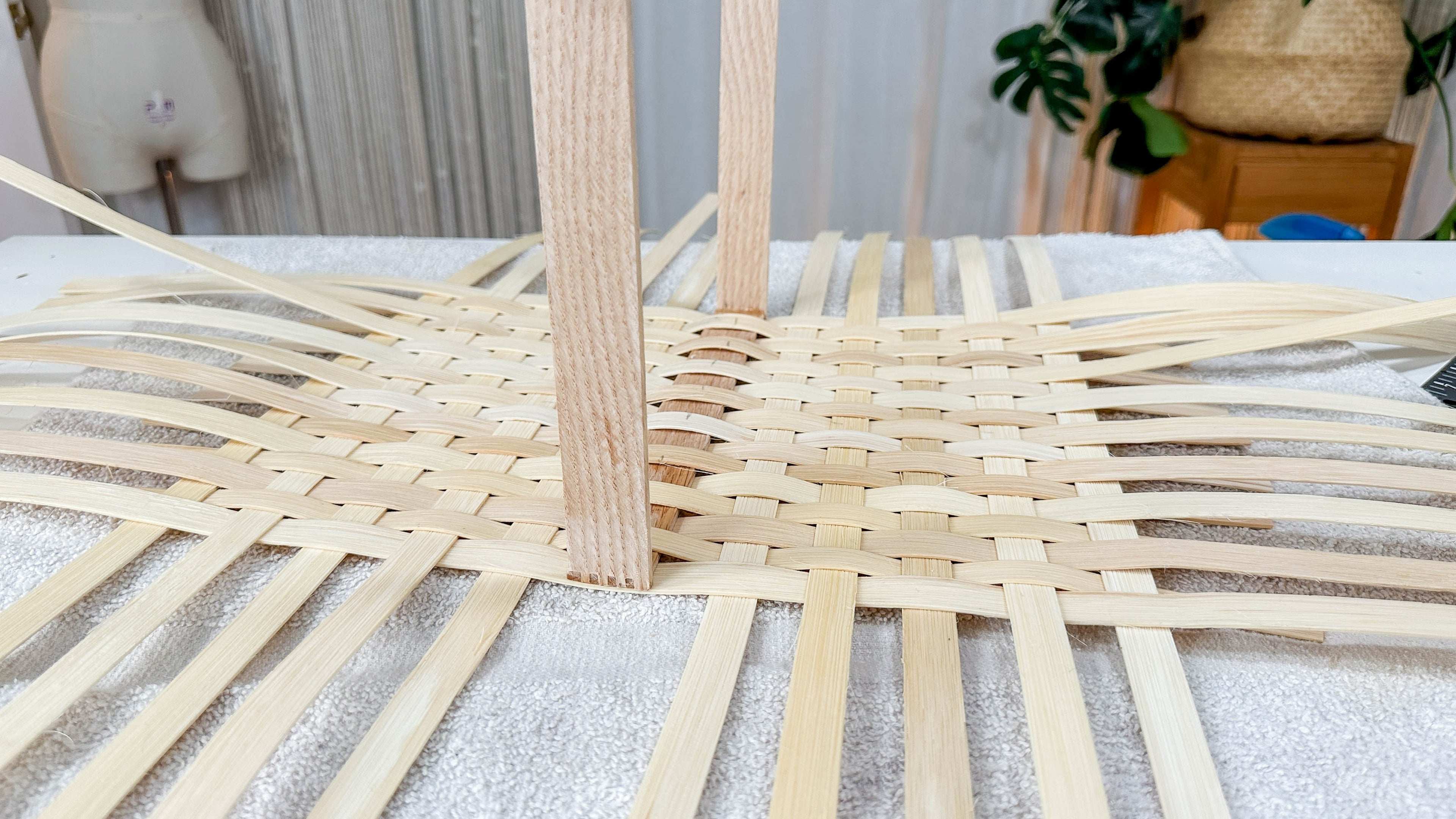 Load video: Braided swing-arm market basket in the weaving process.