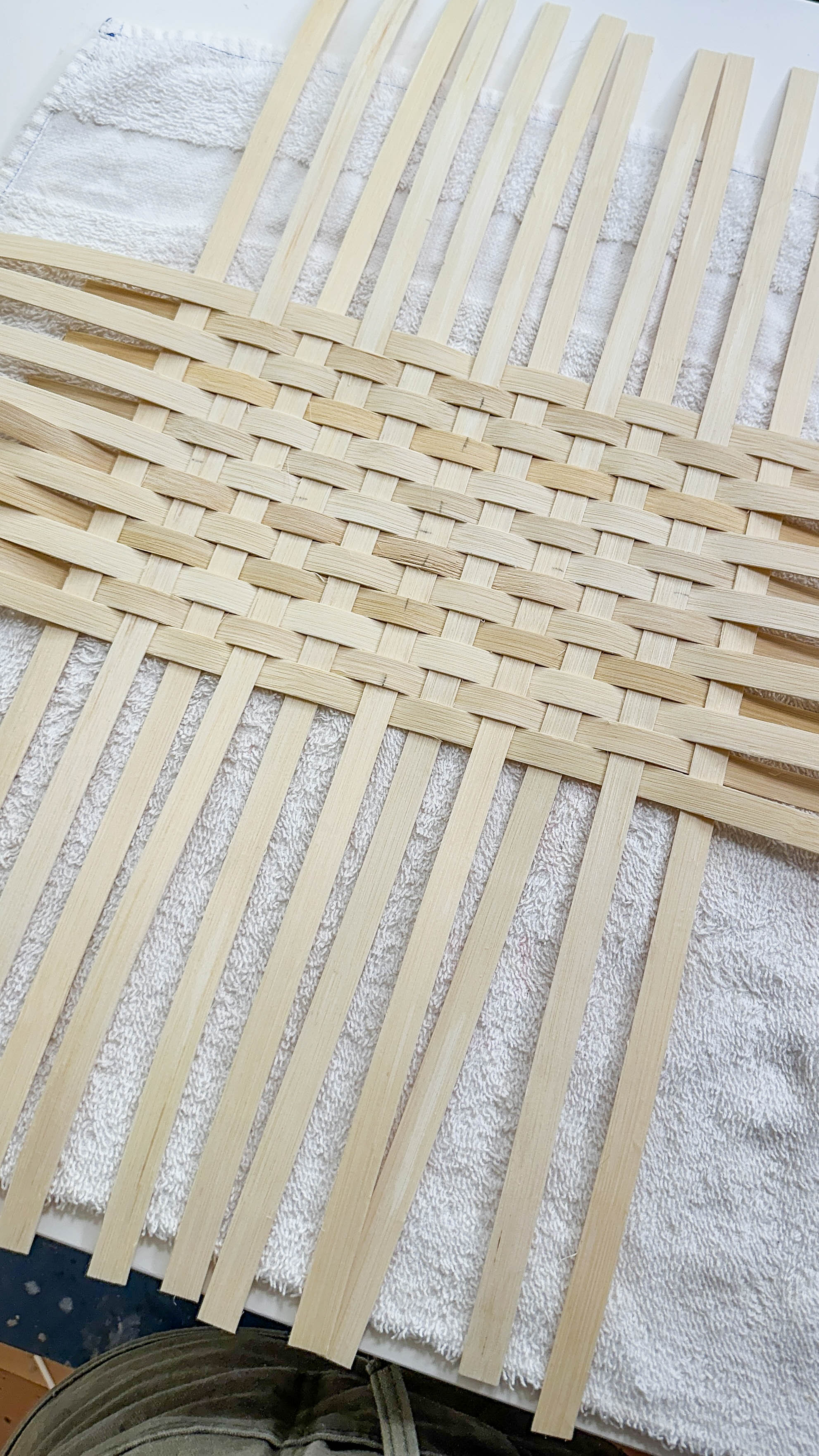 Load video: The handled storage basket is in the process of weaving.