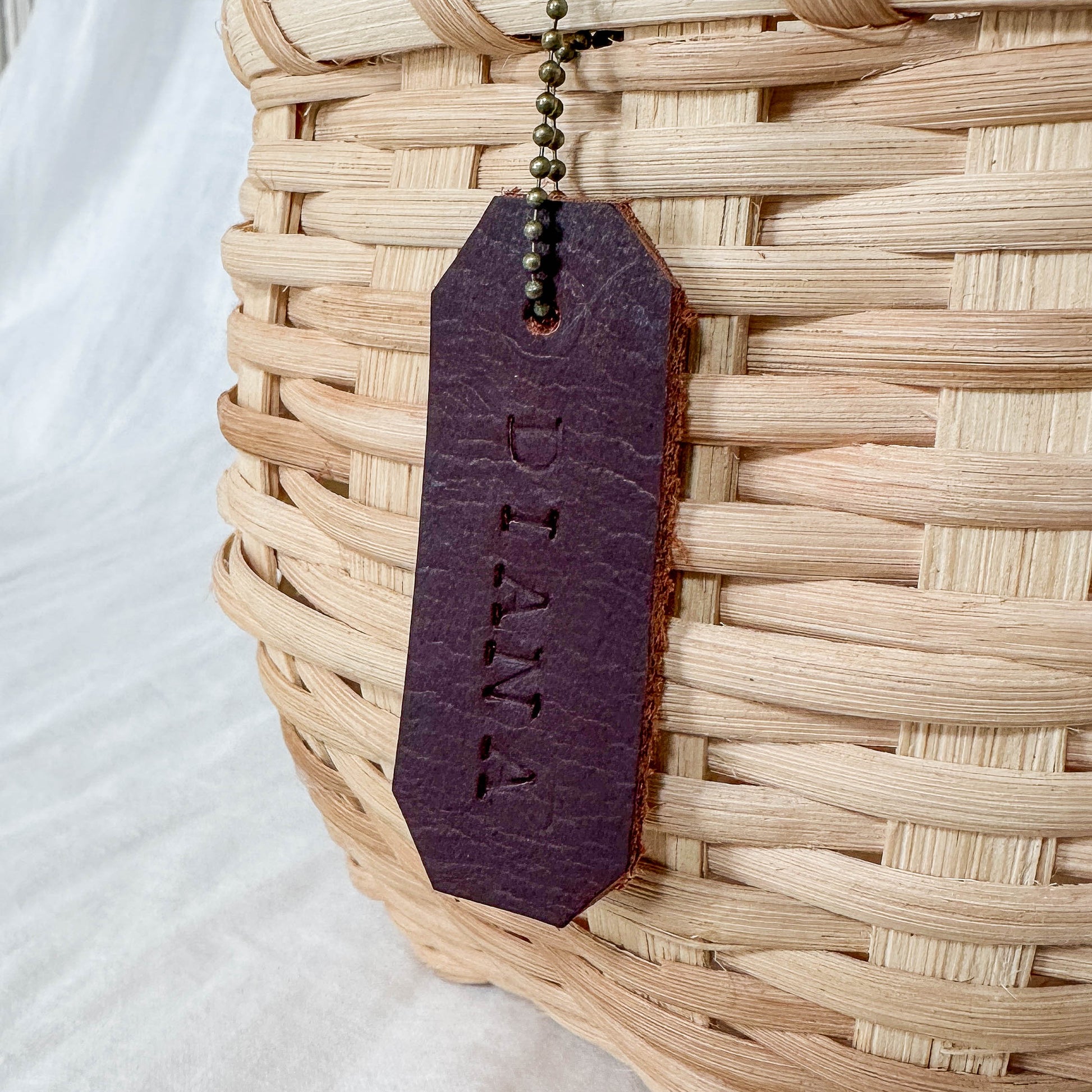 Rattan basket with a leather tag.